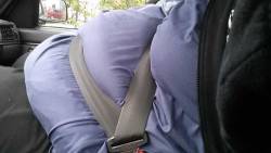 The seatbelt fits perfectly between my fat rolls when i use an extra belt extender.