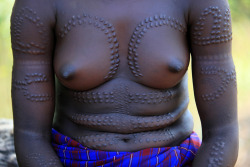 Amazing scarification on the body of a Mursi girl from Angola.
