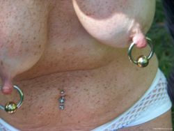 piercednipplegirls:  Her Heavy 4 gauge rings are pulling her nipples down! 
