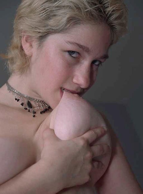 Girl sucking her own nipples