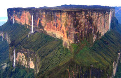 legalmexican:  sixpenceee:  Mount Roraima, South America: This tabletop mountain is one of the oldest mountains on Earth, dating back two billion years when the land was lifted high above the ground by tectonic activity. The sides of the mountain are