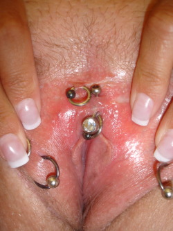 Spread pussy displaying VCH and various rings.