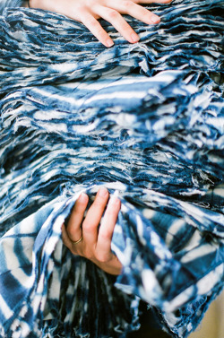  That’s a huge stack of indigo shibori cloths. Shibori is an ancient Japanese technique of folding and clamping that creates a resist, or pattern, on the fabric. 