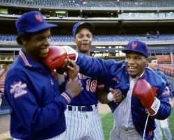 boxingsgreatest:  Mike Tyson throws a mock punch at New York Mets pitcher Dwight “Doc” Gooden as Darryl Strawberry looks on. 
