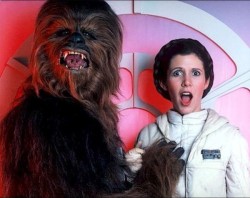Chewbacca (Peter Mayhew) grabs a boob of Princess Leia (Carrie Fisher)