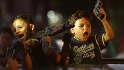 politics-war:  Children hold up guns, one with an empty magazine, from a car as Palestinians gather in the streets to celebrate after a deal had been reached between Hamas and Israel over a long-term end to seven weeks of fighting in the Gaza Strip on