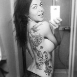 Littlemissbambi shows off her ink in this black and white self shot in the bathroom mirror.