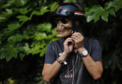 onelegmatt:  The Atlantic: A man wearing a skeleton mask prepares to ride his Harley Davidson motorcycle during the annual Harley Davidson National Rally in Qian Dao Lake, China, on May 11, 2013.