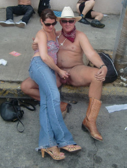 She is in charge of this naked cowboy.