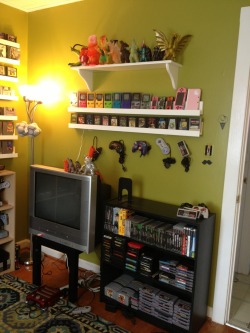 redfromvoid:  My room for old ass games. I built the arcade cabinet and the white shelves. I completed the shelves last night took a step back, admired my work… Then said in my head “you’re a 26 year old lady.” But whatever, I own my own house