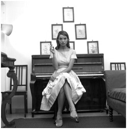 books0977: Elsa Martinelli, at home, seated at her piano, 1957. Photo by Angelo Frontoni. Born Elisa Tia, Martinelli in 1953 was discovered by Roberto Capucci who introduced her to the world of fashion. She became a model and began playing small roles