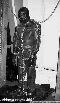 northernleather:  Great way to store a gimp, I wish it was me chained up in that suit. 