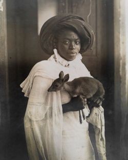 harrowingp:  A young Kenyan woman holds her pet deer in Mombassa, March 1909.Photograph by Underwood and Underwood 