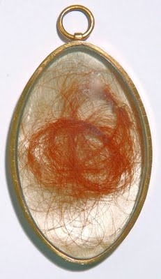 Hair of Mary Tudor, Queen of France, clipped from her head at the opening of her tomb in 1784 encased in a locket.
