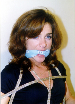 graybandanna:  Kelsie Chambers tied to a chair with a light blue bandanna gag 
