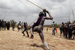  Ethiopia’s Omo Valley, by Olson and Farlow    When the Donga fighting actually begins there is ritualized posturing that culminates with two men beating the crap out of each other by wailing on their opponents with their penis-shaped sticks.  