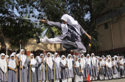 images4images:  An Indian Muslim girl performs martial arts during a function to mark International Women Day at a school in Hyderabad, March 2014. AP Photo/Mahesh Kumar A.2000x1308 