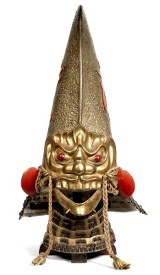 explodingrocks:  Demon Kawari Kabuto Samurai helmet). Mid Edo Period, 18th century, JapanThe simple iron bowl built up to form a naga eboshi with a modeled demons head on the front, the surface of the bowl with a textured finish lacquered gold. On either