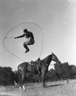 erowid: Cowboy jumps ten feet in the air over the horse, looping himself inside his lasso, near Austin, Texas, undated.