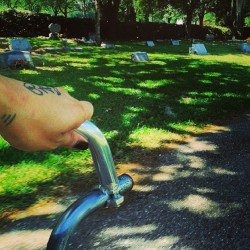 Riding my bike through a cemetary. Kissing the wind, thankful I ain’t in that still ground just yet.