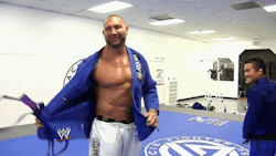 Batista being whipped during his Jiu-Jitsu purple belt ceremony. I am aroused by this &gt;:)