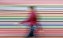 sonjabarbaric:  A woman walks in front of Gerhard Richter’s painting titled Strip during the press preview of the exhibition called Gerhard Richter: Strips and Glass, at the Albertinum in Dresden, Germany.  Photograph: Jens Meyer