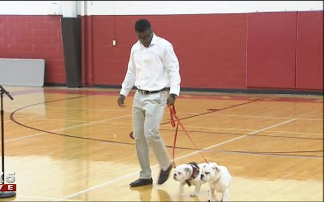 Elijah Holyfield committed to Georgia with two bulldog puppies. (FOX 5)