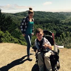 laughingatmynightmare:  Hi Tumblr. My name is Shane Burcaw, and I’m the hipsterly-dressed dinosaur creature in the wheelchair above. The beautiful girl is my girlfriend Anna. We were climbing a mountain (in Tom’s and khakis, obviously). I need all