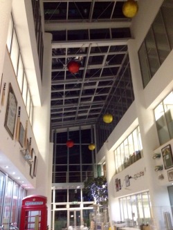 So apparently this year the people who run the building I work in decided what it really needs to make it festive is giant glittery red and yellow baubles hanging from the roof