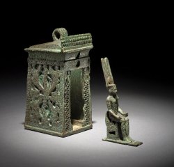 lordofkobol:  The British Museum  Bronze amulet in the form of a naos; the two sides are decorated with two registers containing above standing and below kneeling winged goddesses wearing the sun-disc and protecting seated mummiform figures of ram-headed