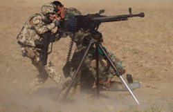 militaryarmament:  A German Bundeswehr soldier with a OMLT unit fires a DShK 12.7×108mm Heavy Machine Gun during a training session with Afghan National Army soldiers on October 12, 2010 in Feyzabad, Afghanistan.