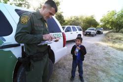 genericlatino:  via The Dallas Morning News,  A Border Patrol agent reads the birth certificate of Alejandro, 8 — the only thing he brought with him as he and others crossed the Rio Grande near McAllen recently. Alejandro is one of more than 52,000