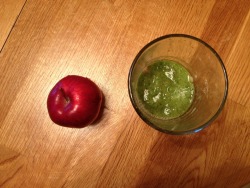 green smoothie of banana kale and apple &amp; an intact apple for breakfast.