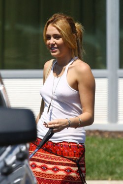 no-bra-celebrities:  Miley Cyrus pokies in see-through shirt Why do you think she goes out dressed like that?