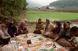 hopeful-melancholy:   Iranian women share lunch after planting rice.    Mazandaran Province. Near the village of Zirab.  Iran, 2001.  A.Abbas 