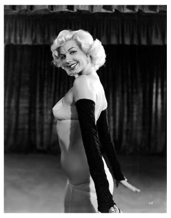 Misty Ayres Poses for a publicity still for the 1953 Burlesque film: “A NIGHT IN HOLLYWOOD”.. The film was shot at the ‘FOLLIES Theatre’; located in downtown Los Angeles..