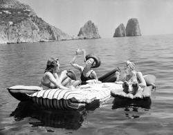 hauntedbystorytelling: Three young women eat spaghetti on inflatable mattresses at Lake of Capri, 1939  (AP Photo / Hamilton Wright)  