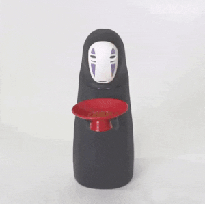 urbnbullshitters:  The Kaonashi No-Face Piggy Bank is a money box that automatically takes your coins and saves them for a later date. Place a coin in Kaonashi’s red bowl and then the spirit will “swallow” the money as music plays from the movie