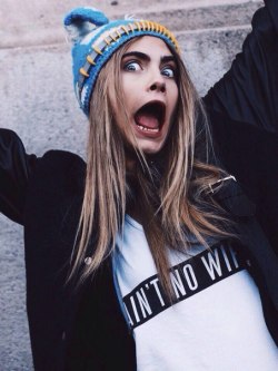 Cara Delevingne wearing Feminist tank top saying “Ain’t no wifey”