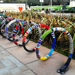Bike rack #knittingbomb cozies outside of the #deyoung museum. One of the most #sanfrancisco things I&rsquo;ve seen in a loooooong time. #knitting #knitbomb #bikes