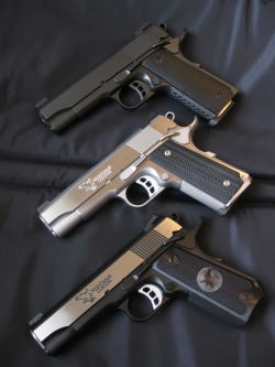 gunsknivesgear:  Nighthawk 1911s. A shooter’s fever dream - a trio of custom 1911 pistols.  Heavy .45 caliber goodness.