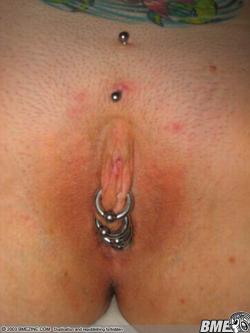 pussymodsgalore  Christina piercing at the top, then pierced outer labia closed with four rings. Chastity piercing. 