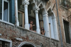 rouxet:  i saw these two girls while riding a gondola in venice. they were smoking and chatting on their windowsill, waving at passing boats. i thought they were incredibly lucky; i would love to share an apartment with my friend or sister in the most