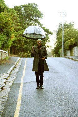 blackfashion:  Young Male Student: AnDre, 21, Cape Town - South Africa. Style: Black theme layer under 3/4  olive colored coat, along with a stylish black lined transparent umbrella and finished off with a complementary gold accessories; gold chain and
