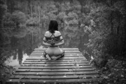 I always love this position, especially the hands.  Like a pet is meditating on her place.  And in such a serene setting -  she should be appreciative of her owner for providing such a tranquil place to contemplate her service.
