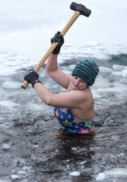 jaw8jaw:Alice Goodridge using a sledgehammer to break up the ice at Loch Insh in the Scottish Highlands before her morning swim. Photo by Euan Cherry, February 2019. 