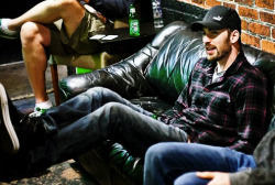 Chris Evans with face scruff, wearing plaid and a baseball cap and my eyes keep getting drawn to the guy in the shorts.