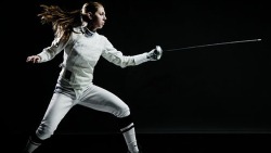 modernfencing:  [ID: an epee fencer with her mask off, doing footwork with her weapon.] Susie Scanlan! 