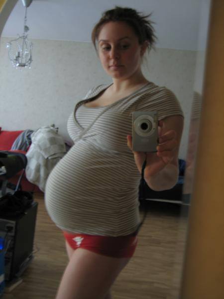 Teen showing her pregnant belly