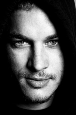 Gorgeous photoshoot of Travis Fimmel.  On the close up photo #4, click on it and zoom in on the eye color; there are various shades of blue, green, and grey with a darker ring circling the iris, making his eyes that much more striking.